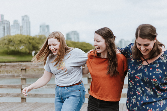 three women walking and laughing together
