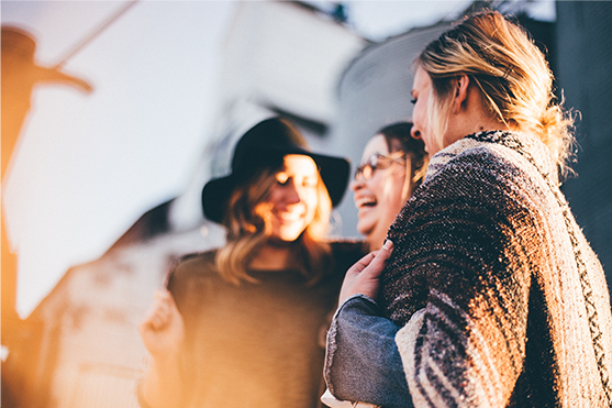 three women talking and laughing