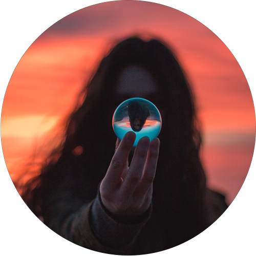 a figure holding a glass sphere